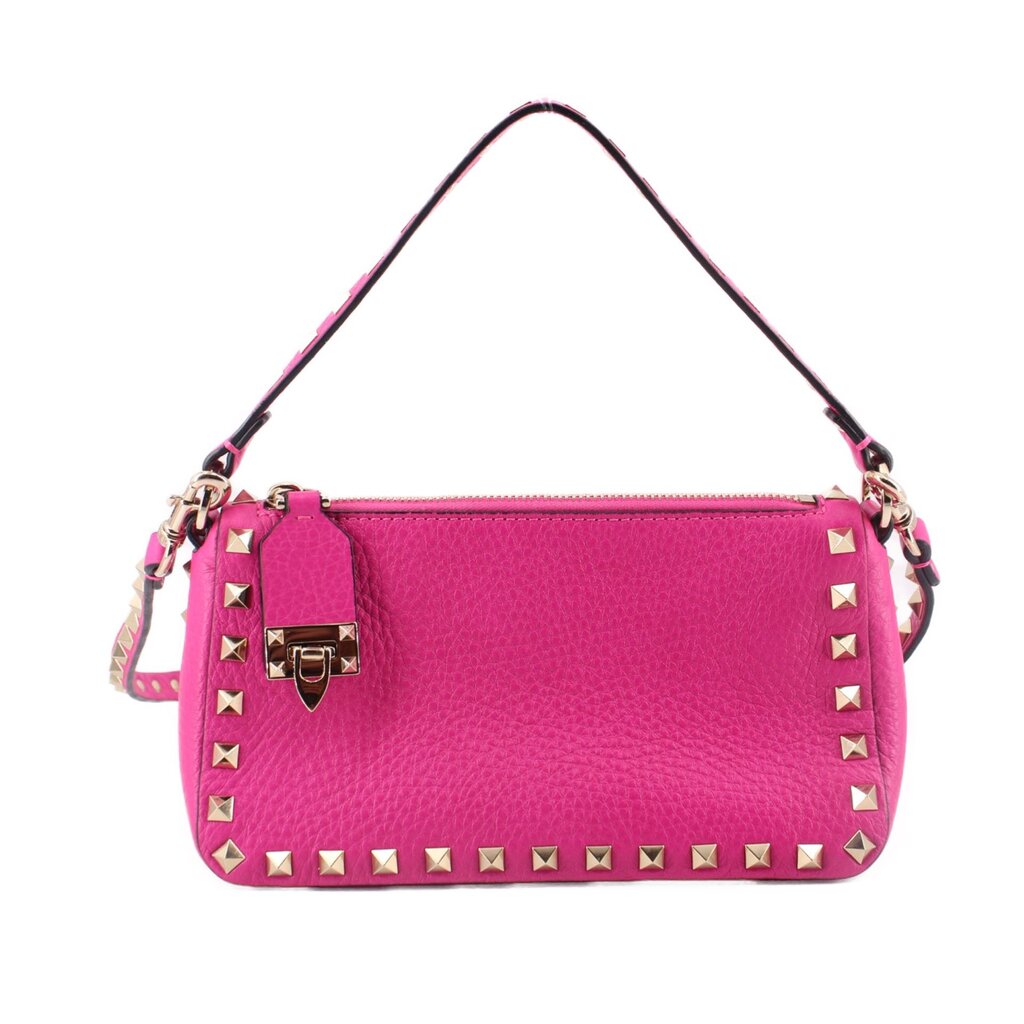 Pink crossbody bag with gold-tone studs, front flap, and short shoulder straps