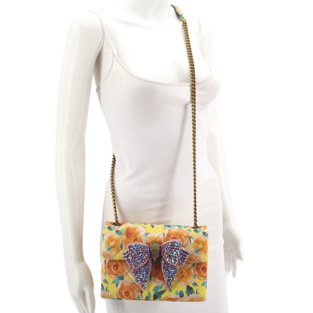 Kurt Geiger floral crossbody bag worn with long chain strap and jeweled bow