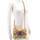 Kurt Geiger floral crossbody bag worn with long chain strap and jeweled bow
