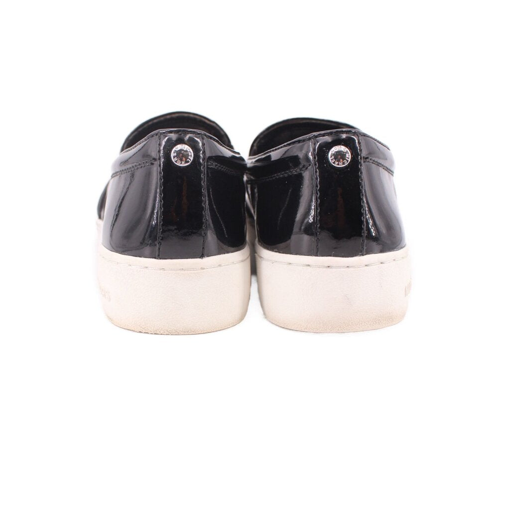 Black patent slip-on sneakers, heel view, with white midsoles