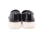 Black patent slip-on sneakers, heel view, with white midsoles