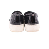 Black patent slip-on sneakers, heel view, with white midsoles