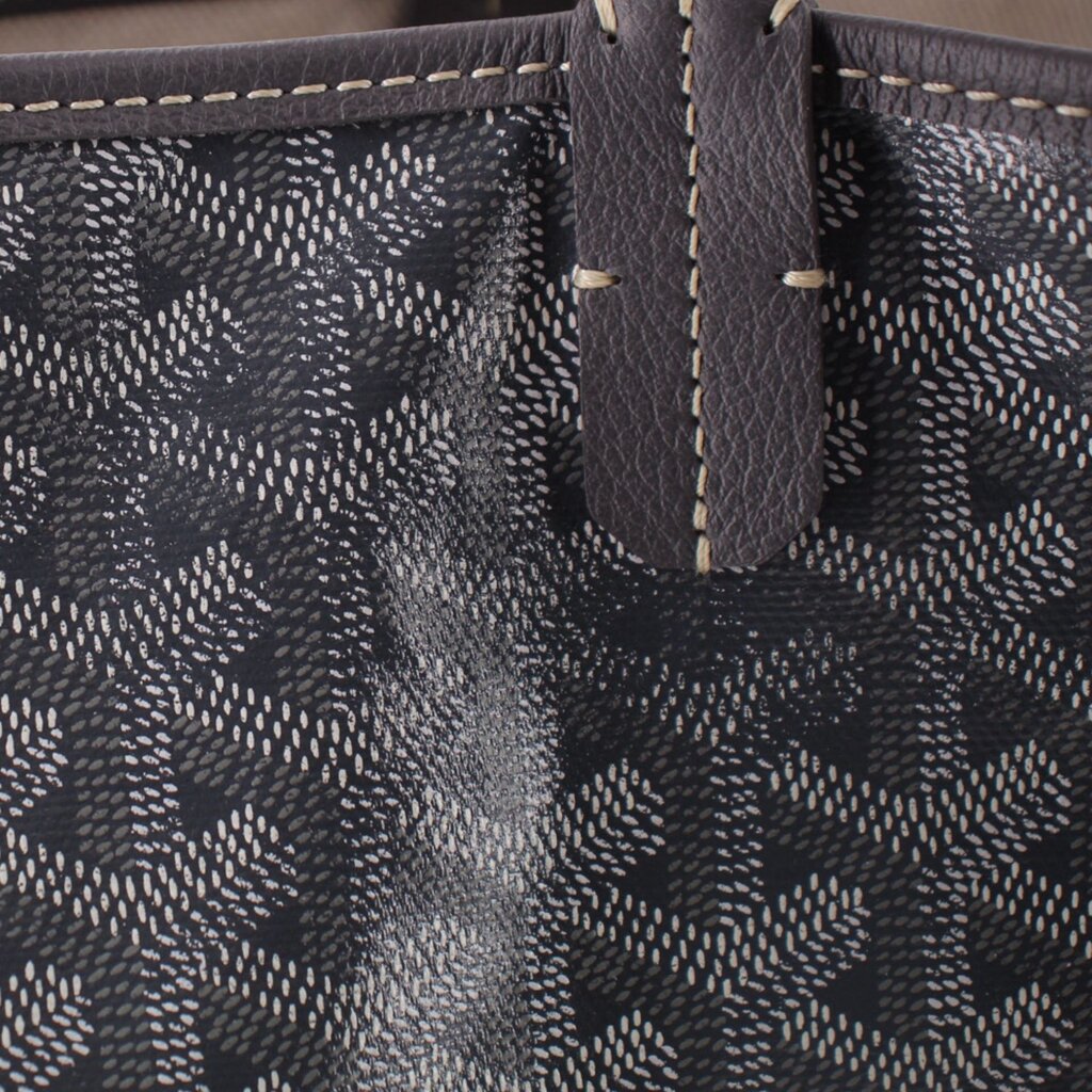 Gray Goyard tote corner with leather patch and contrast stitching