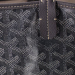 Gray Goyard tote corner with leather patch and contrast stitching