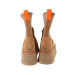 Tan suede boots with UGG logo on heel, orange pull tabs, and platform sole