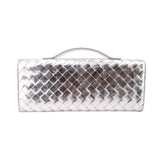 Silver metallic quilted clutch with top handle, front panel view
