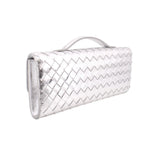 Silver metallic woven clutch with top handle and clasp, side profile