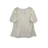 White embroidered blouse top with short sleeves, rounded neckline, relaxed fit