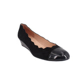 Black wedge flats with scalloped upper and glossy toe cap
