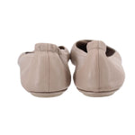 Taupe leather flats with low heel and stitched back, rear view