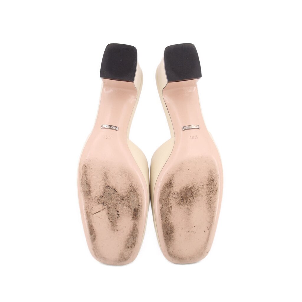 Gucci mule heels underside view with light beige soles and dark heel openings