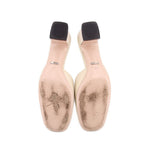Gucci mule heels underside view with light beige soles and dark heel openings
