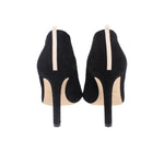 Black suede heeled booties, back view with stiletto heel and light elastic pull tab