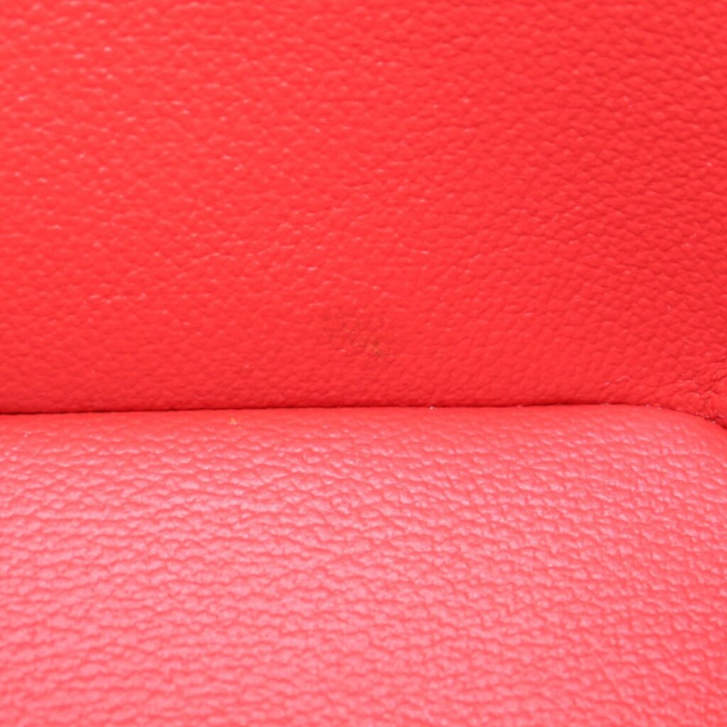 Red leather interior surface with stitched seam detail