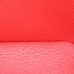 Red leather interior surface with stitched seam detail