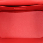 Red leather interior panel with stitched trim and upper flap edge