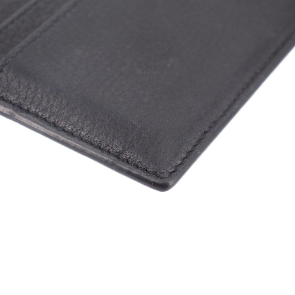 Black leather card case with textured grain and visible edge stitching