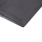Black leather card case with textured grain and visible edge stitching