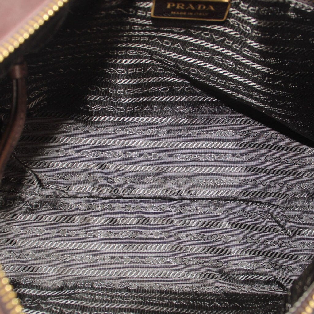 Interior fabric of PRADA crossbody bag with repeating pattern and PRADA label