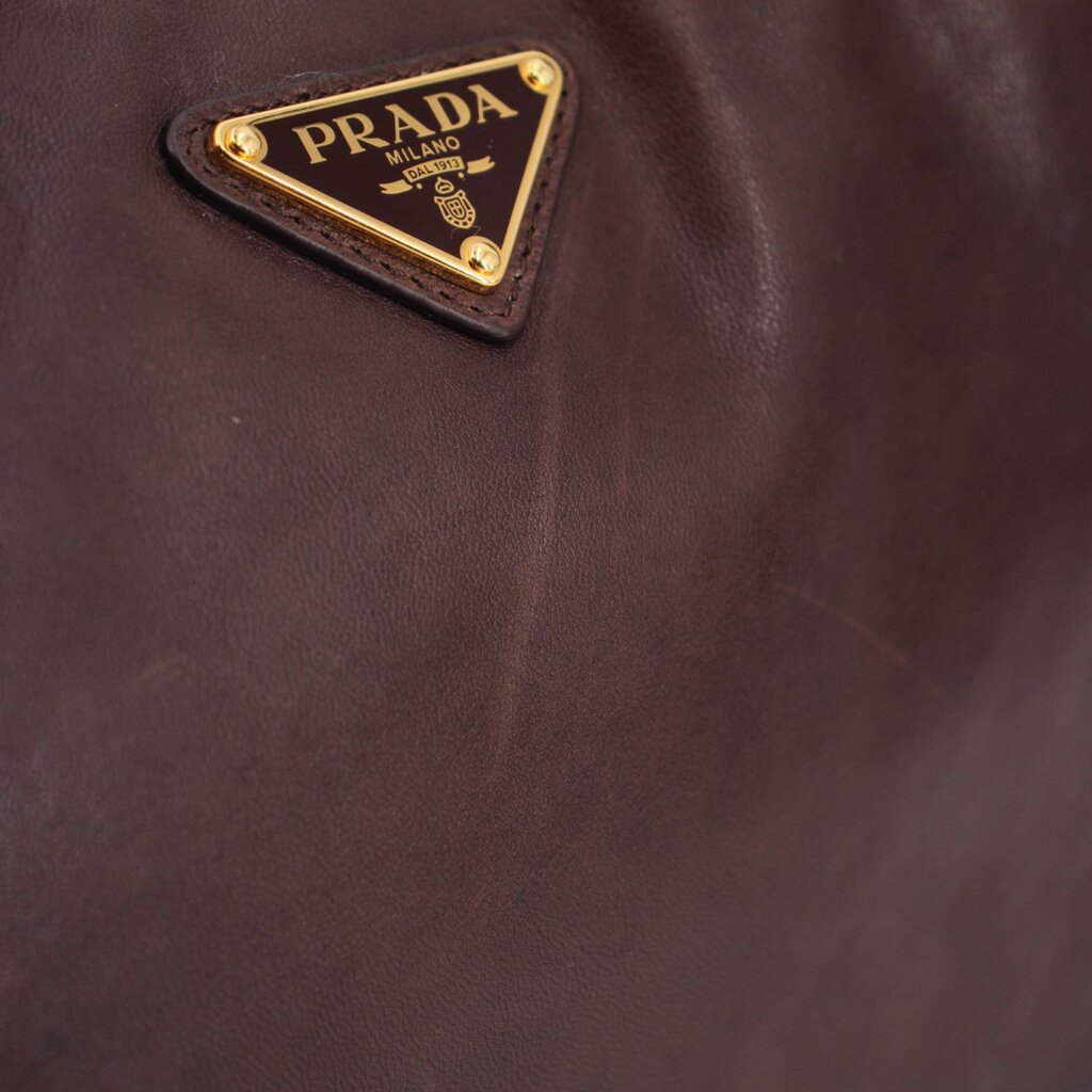Prada logo plaque on brown leather crossbody bag