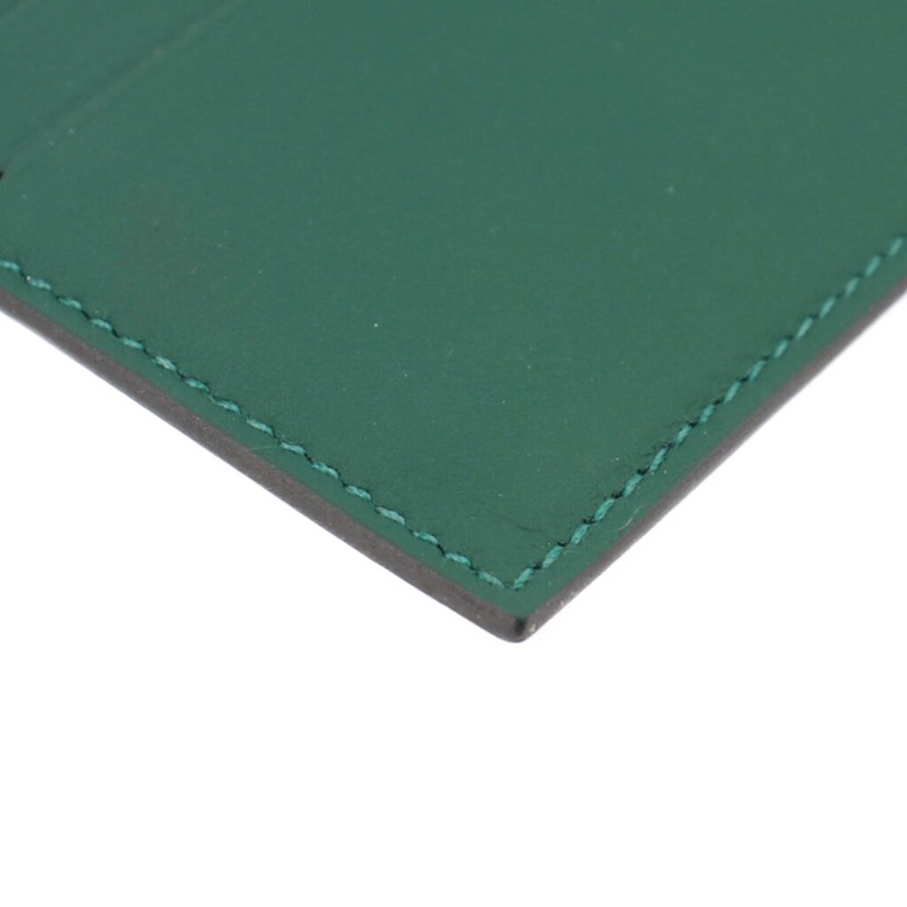 Green leather card case corner with double-stitched edge seam detail