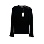 Black bell-sleeve sweater with crew neck and small gold emblem at neckline