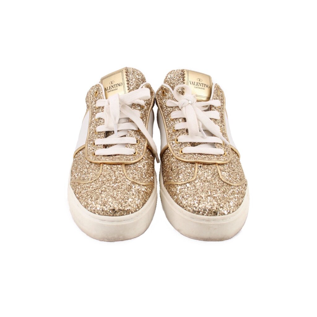 Pair of glitter sneakers with front laces and gold sparkle finish