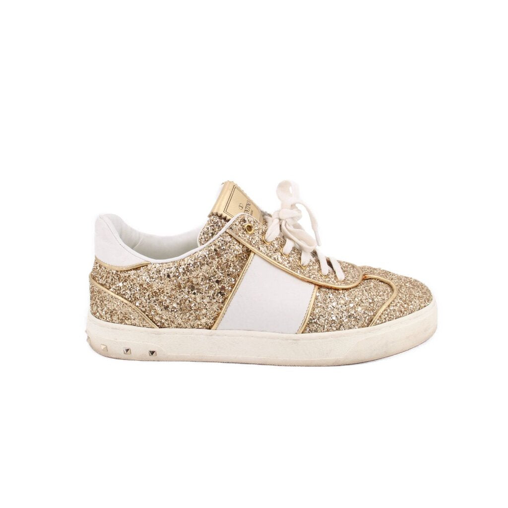 Low-top glitter sneakers with gold sparkle uppers, white side stripe and laces