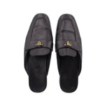 Black leather slide loafer, front view, with gold PRADA logo buckle