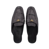 Black leather slide loafer, front view, with gold PRADA logo buckle