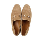 Pair of tan suede horsebit loafers, front view with metal bit hardware