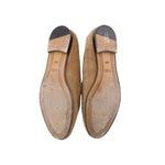 Tan suede horsebit loafers, bottom view showing leather sole underside
