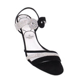 Black heeled sandals with rhinestone bow detail and ankle strap