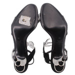 Black heeled sandals with rhinestone ankle straps and embossed heel interiors