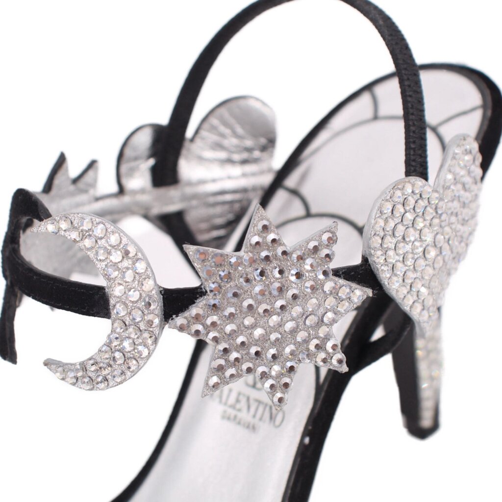 Close-up of black heeled sandal with star-shaped rhinestone embellishment