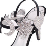 Close-up of black heeled sandal with star-shaped rhinestone embellishment