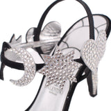 Close-up of black heeled sandal with star-shaped rhinestone embellishment