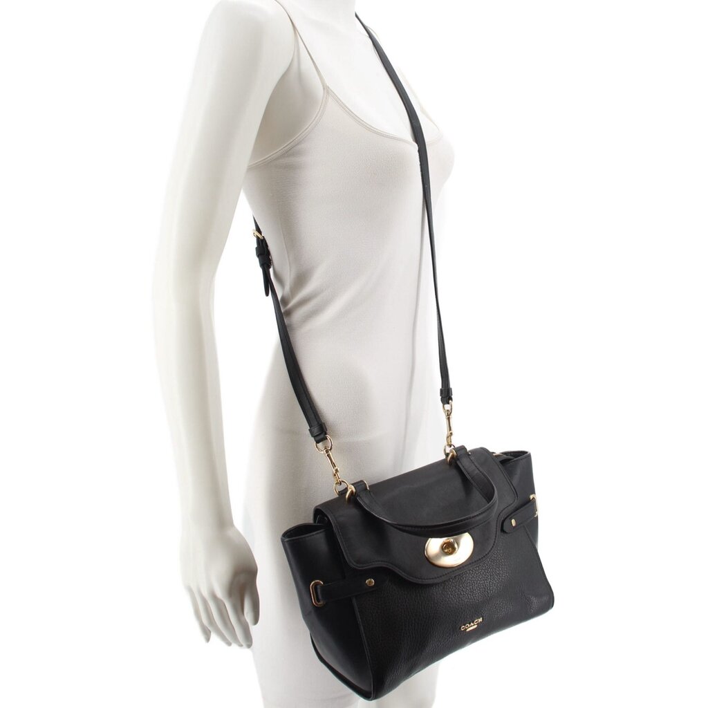 Black leather crossbody bag worn on mannequin, front flap and shoulder strap visible