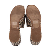 Bottom view of woven espadrille platform sandals with brown soles and zigzag sidewalls