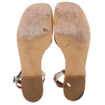 Beige sandal soles with textured undersides and strap cutouts at the foot