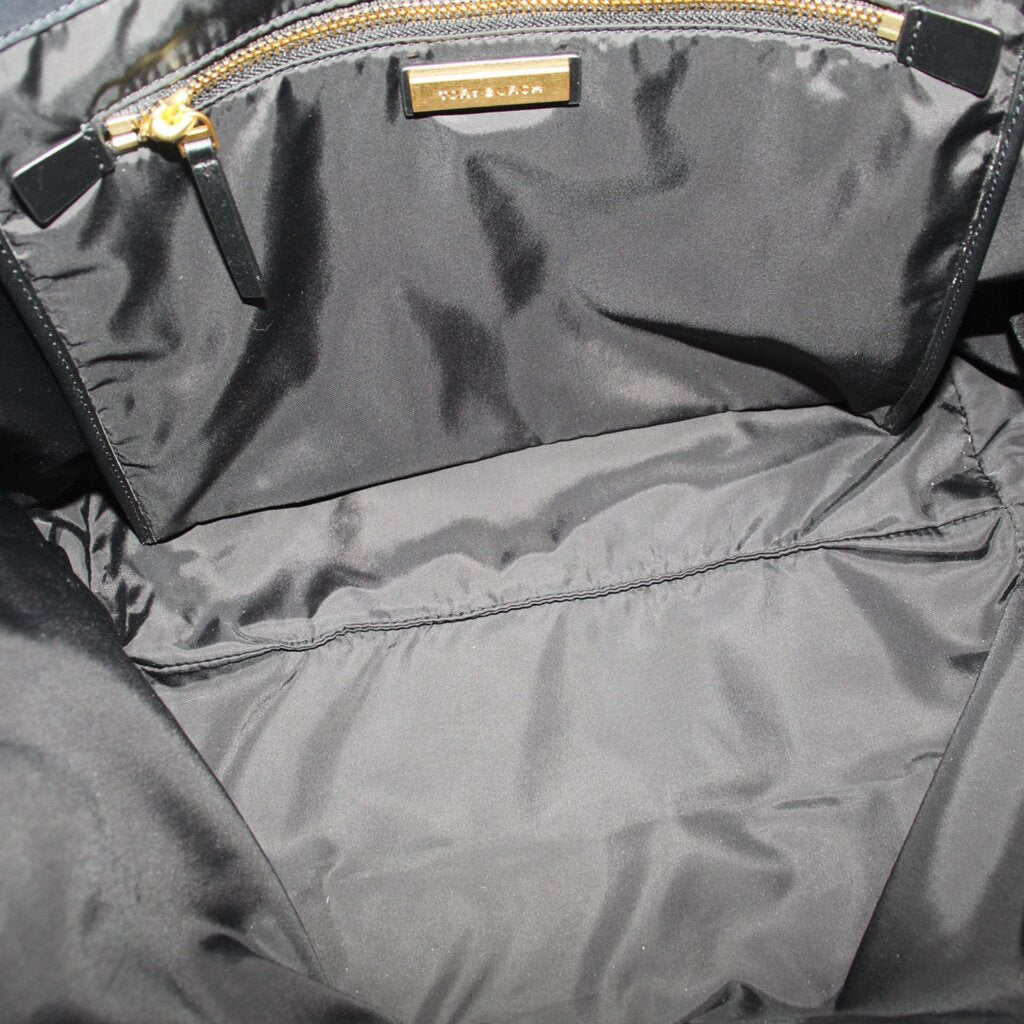 Tote interior lining with brand label and zipper track at top edge