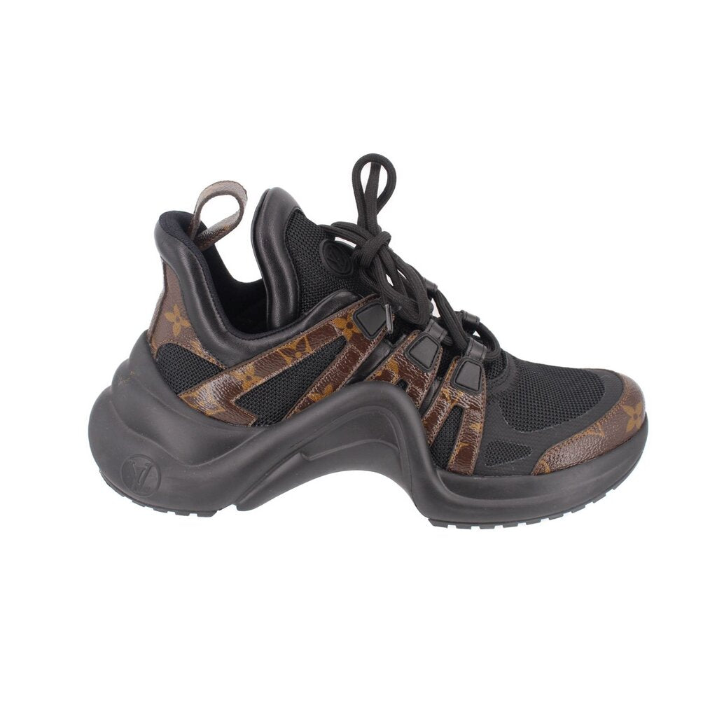 Archlight sneakers side view, black uppers with tan monogram stripe, lace-up