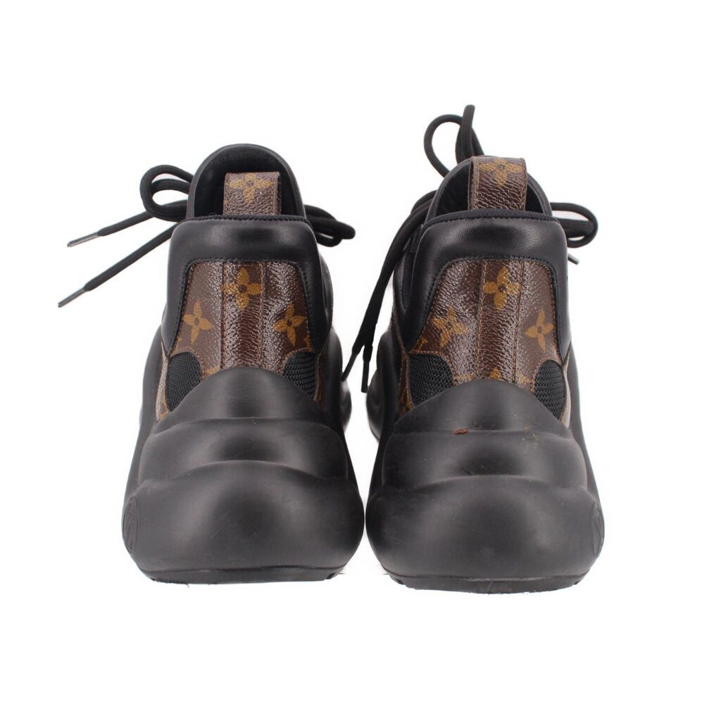 Archlight sneakers back view, black heel leather with tan monogram detail, lace-up