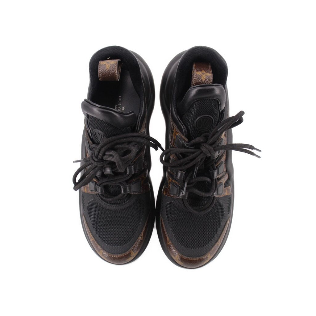 Pair of Archlight sneakers front view, black mesh with tan monogram toe accents