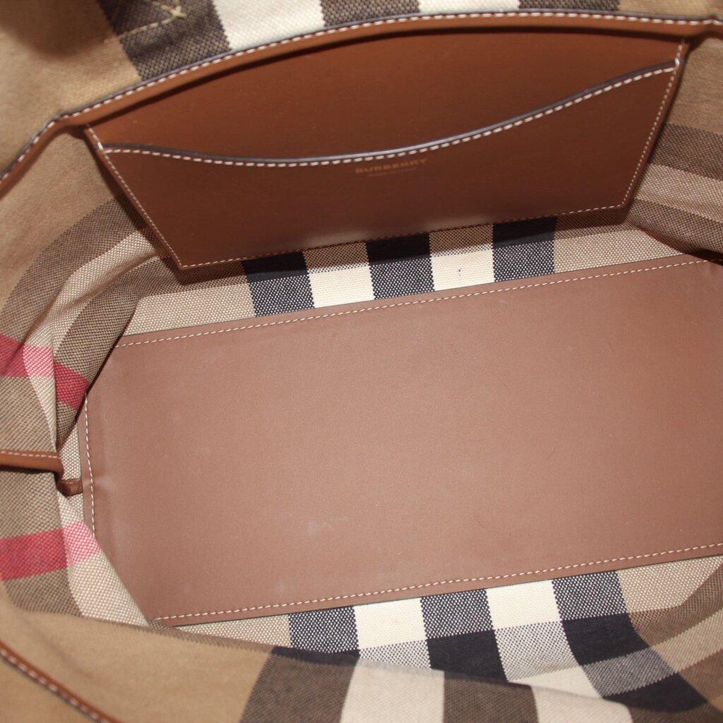 Tote bag interior with brown leather-lined compartments and beige check canvas