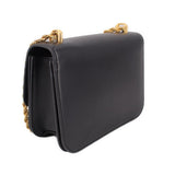 Black leather crossbody bag with braided chain strap and curved flap