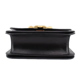 Black leather crossbody bag underside view with snap clasp and flat base