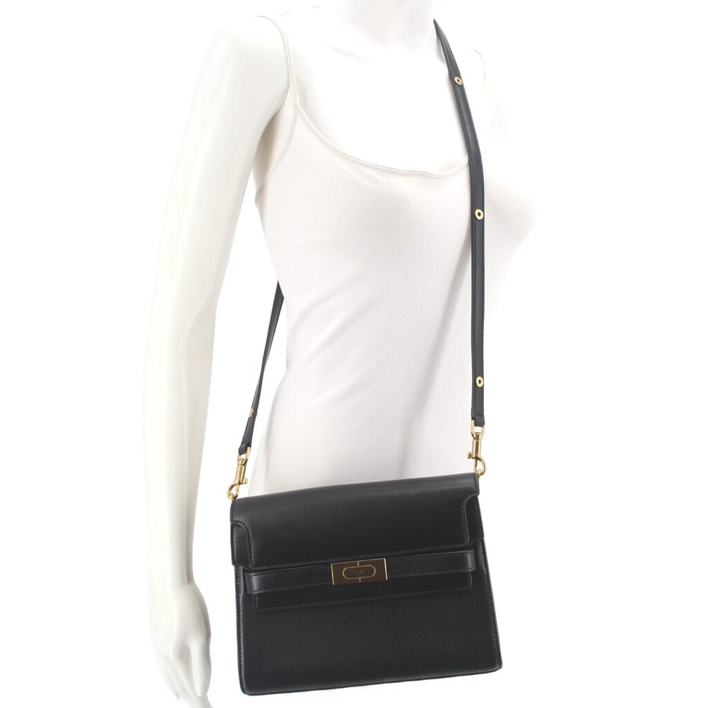 Black leather crossbody shoulder bag with front flap, gold logo tab, and chain strap