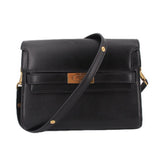 Black leather shoulder bag with flap, gold hardware, and adjustable crossbody strap