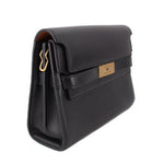 Black leather shoulder bag side view with front flap and gold-toned logo tab